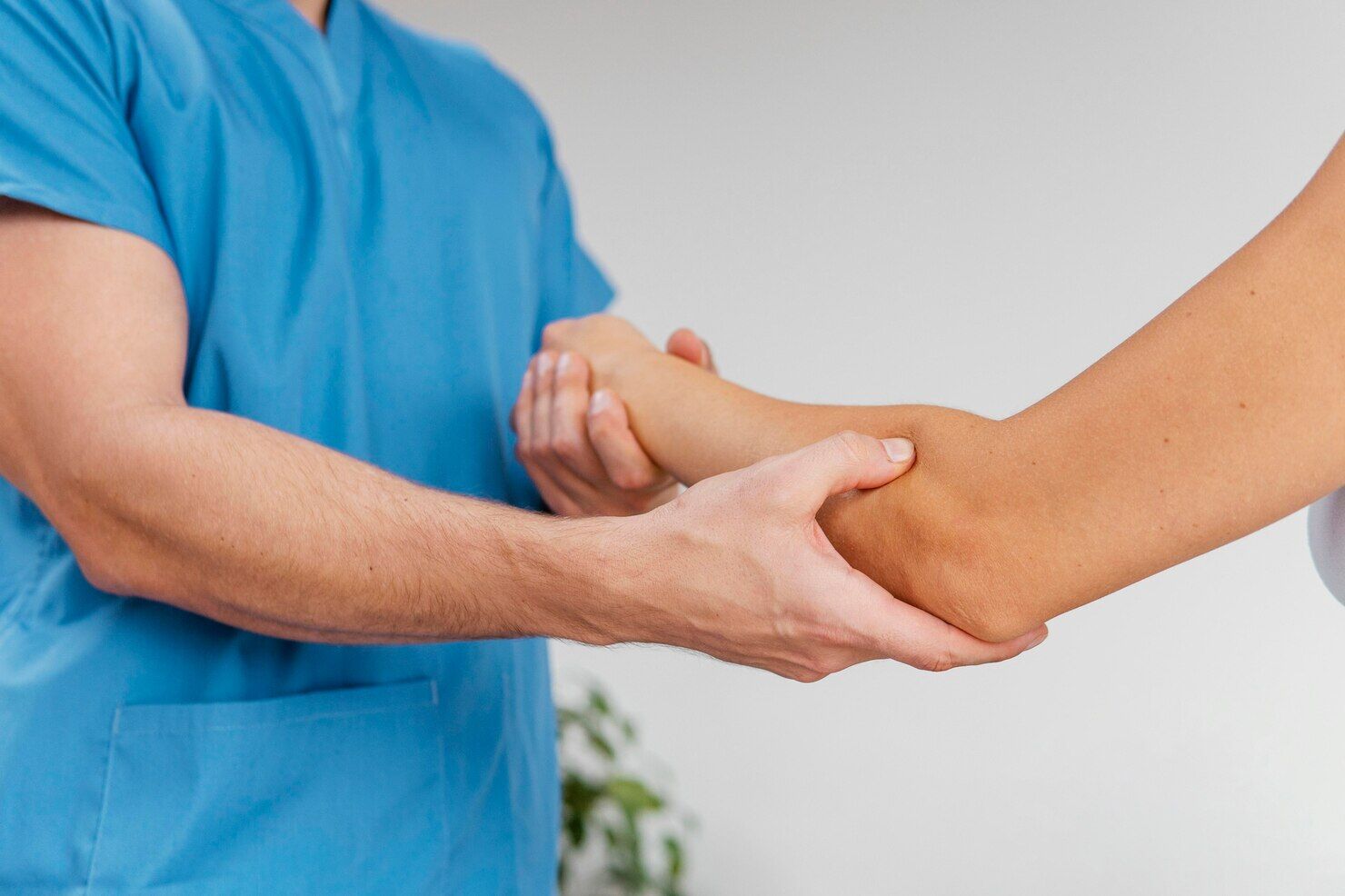 Therapist Checking Female Patient Elbow
